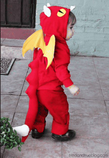 Dragon costume on child walking.