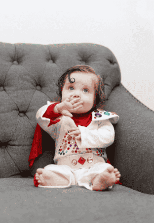 Baby Elvis costume in chair.