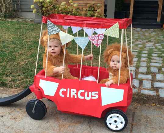 Children in lion costume in wagon.