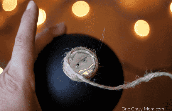 Twine being glued to the top of ornament.