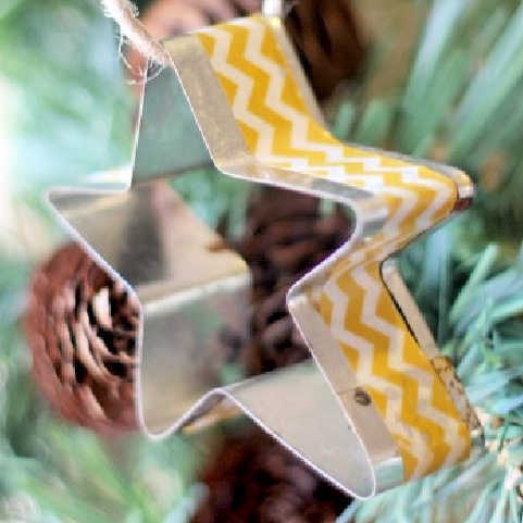 Star ornament with washi tape in tree.