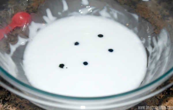 Bowl of blue with drops of food coloring.