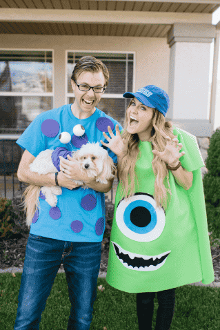 Mike and Sully costumes on man and woman in the yard.