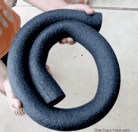 Pool noodle being formed into a circle.