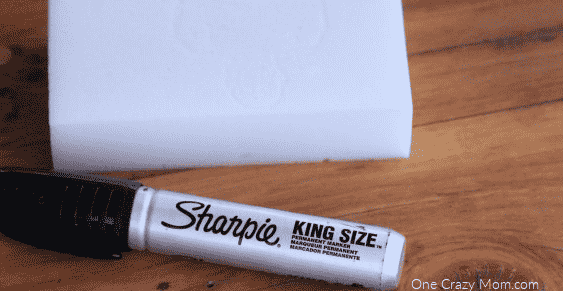 Magic eraser and sharpie on table.