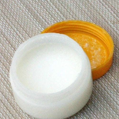 Face moisturizer inside an open jar.