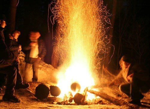 Campfire with kids around it.