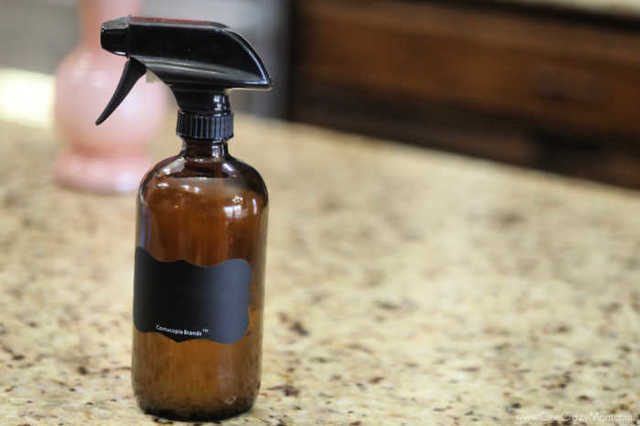 How to clean granite countertops easily with this Homemade Granite Cleaner. DIY granite cleane is easy and much cheaper than store bought granite cleaners. Bottle of granite cleaner on the counter.