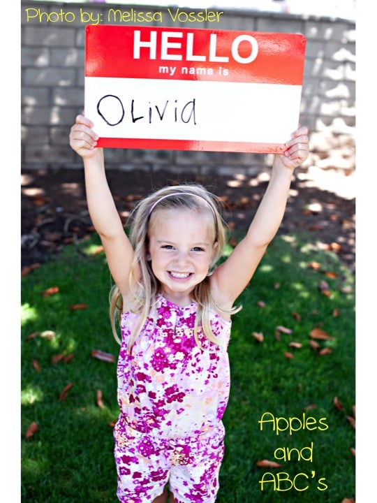 Here are 10 fun first day of school picture ideas. These first day of school picture ideas are perfect for back to school. Try one of them this year! Nametag sign held by child.