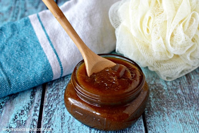 Brown sugar scrub in jar with spoon.
