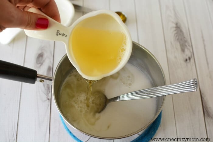 Castile soap being poured into the mixture.