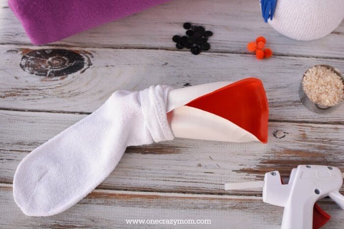 Sock with paper plate inserted to add rice.