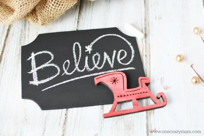 Chalkboard sign with Believe written on it.