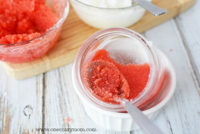 Red sugar scrub pushed down with a spoon.