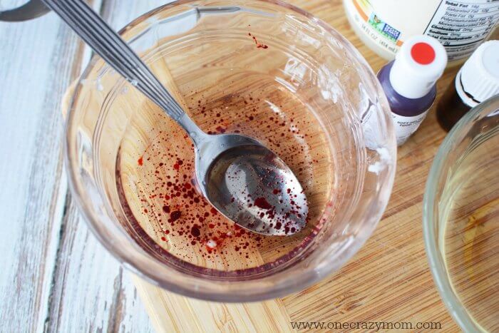 Food coloring and oil in a bowl.