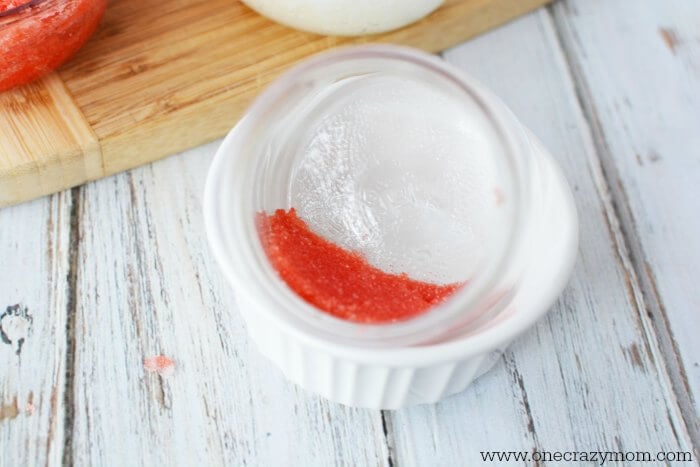 Red sugar scrub layered in a jar.
