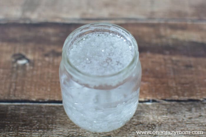Jar being washed with soap and water.