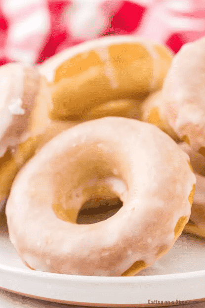 Glazed donuts in a pile.