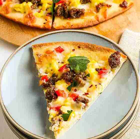 Breakfast pizza on plate.