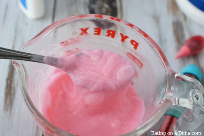Spoon stirring slime mixture.
