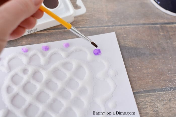 Watercolor being painted on glue.