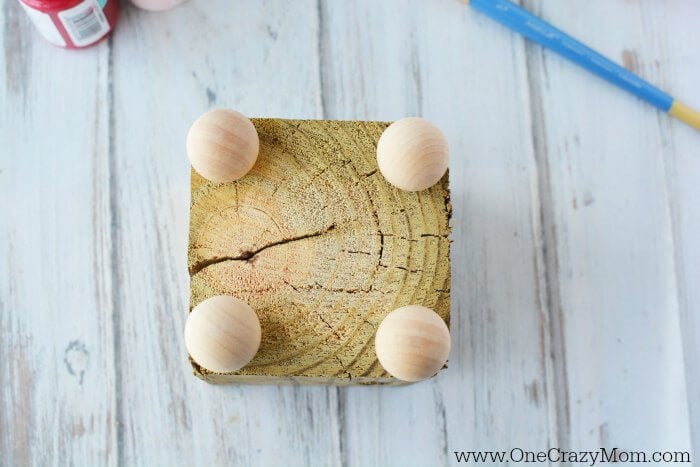 Wooden balls attached to the bottom of block.