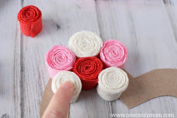 Glue the paper flowers on to the wreath form.