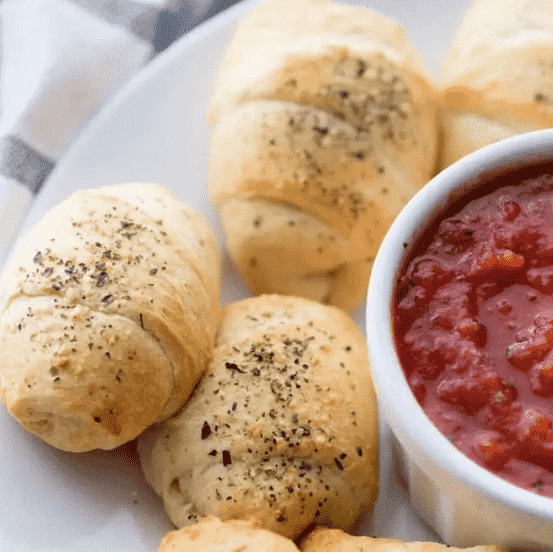 Crescents on platter with dipping sauce.
