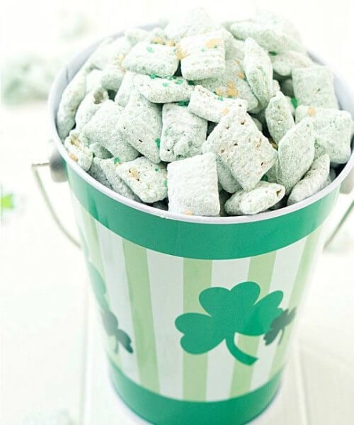 Everyone will love these fun St. Patrick's Day desserts. Find over 15 easy St Patrick's Day Desserts. Festive desserts and snack ideas sure to be a hit. Puppy Chow in bucket.