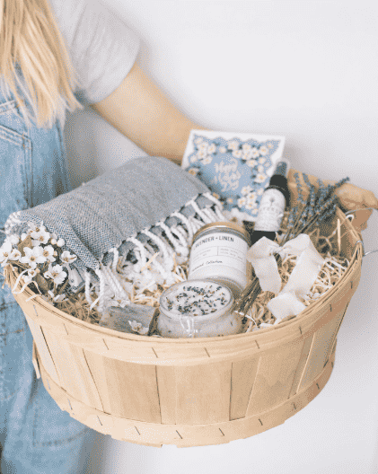 Basket with body scrub, throw and candle.