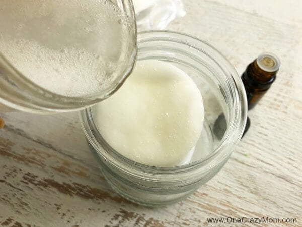 Water being poured into mason jar with makeup pads.