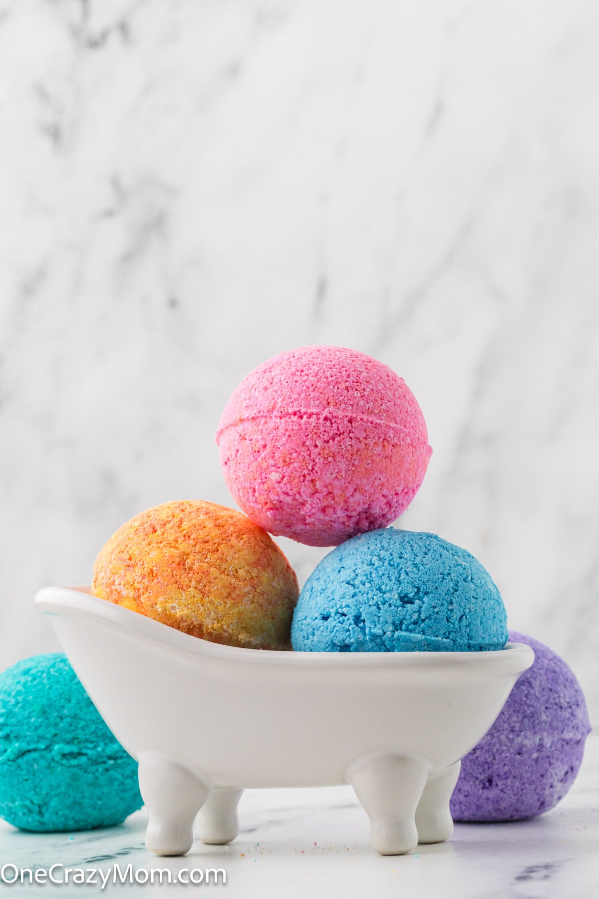 Bath bombs stacked in a container and ready to use.
