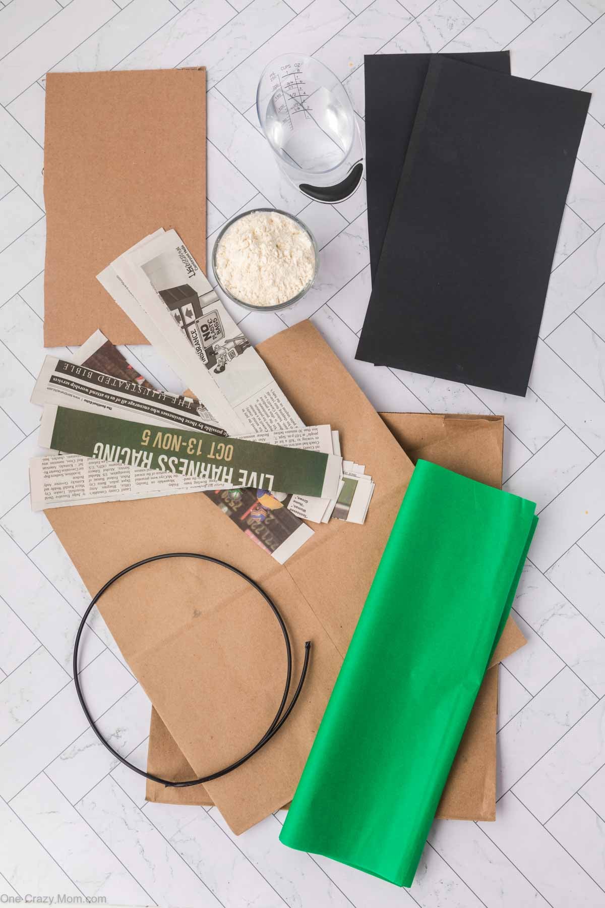 Supplies for Minecraft Pinata - brown paper bags, cardboard, wire, newspapers, flour, water, tissue paper and construction paper.