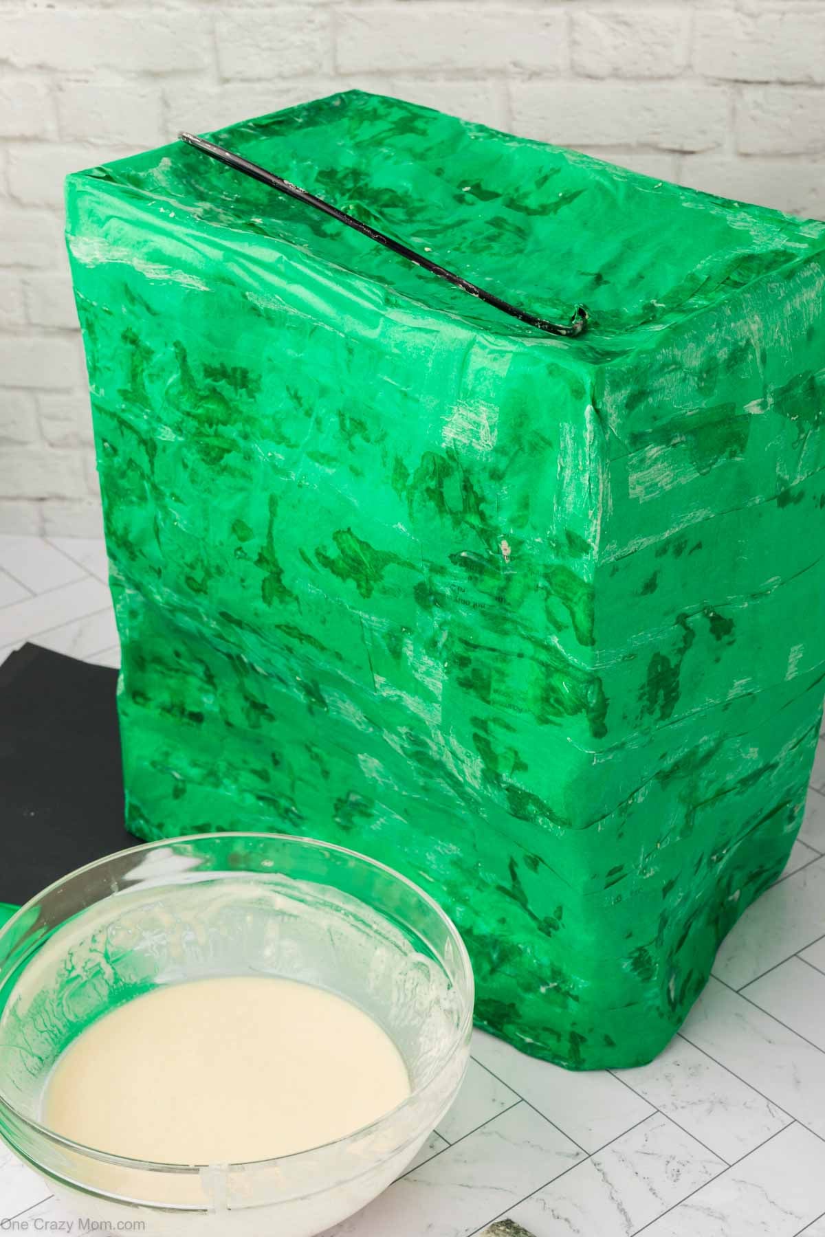Green tissue paper added to the pinata.