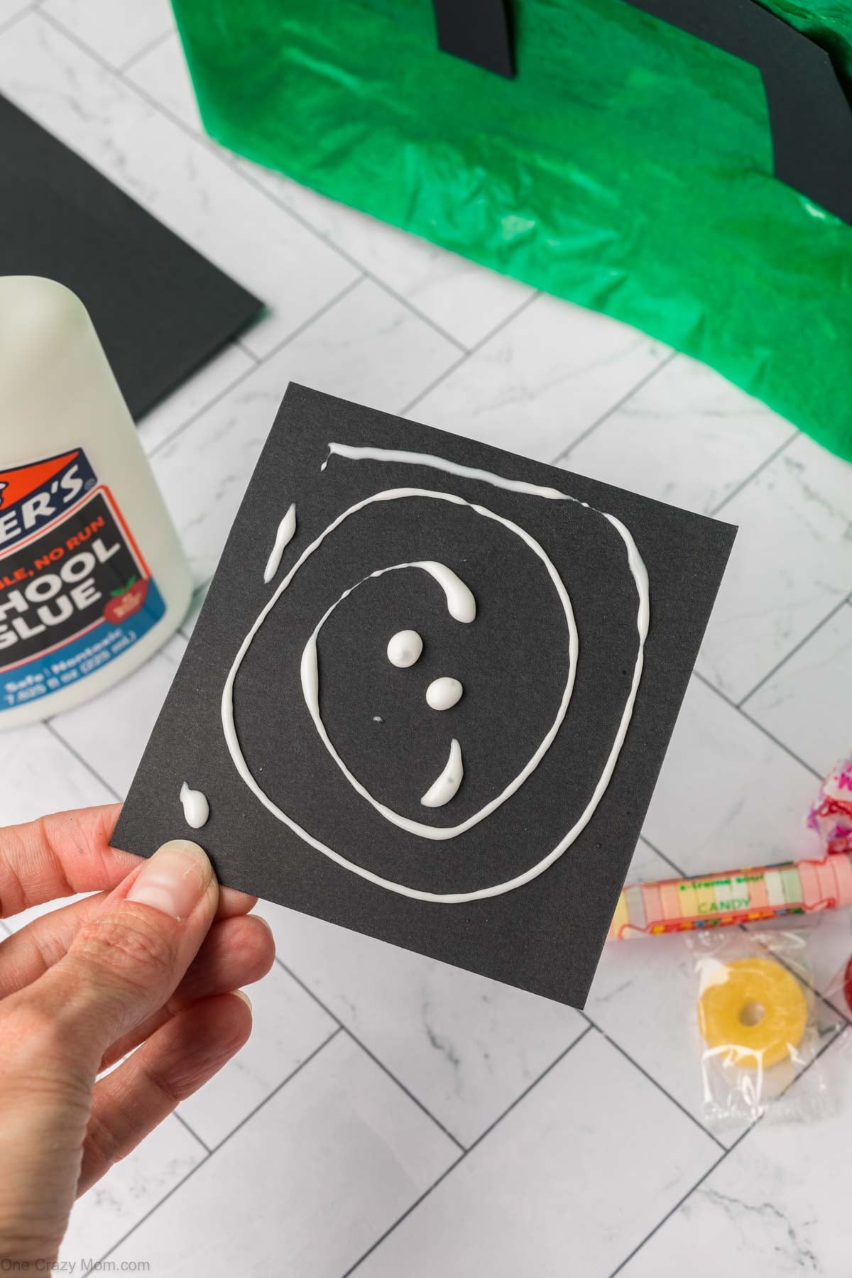 Creeper face added to pinata bag using black construction paper.
