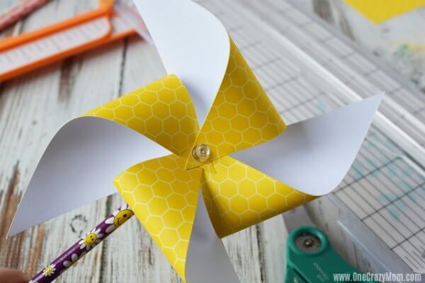 Thumb tack inserted into the center of the pinwheel.