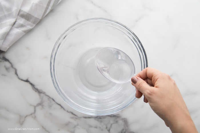 Bowl of vinegar and hydrogen peroxide being combined.