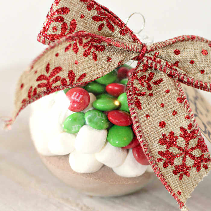 Hot Cocoa in an ornament with a bow.