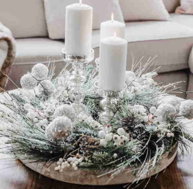 Candles with greenery on a tray.