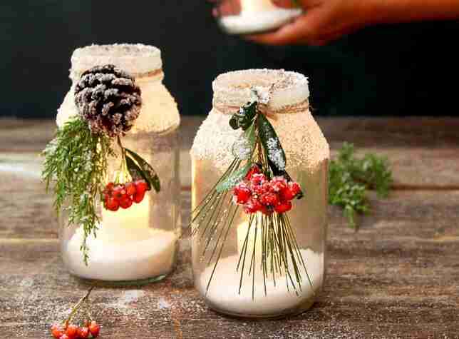Mason jars with snow and candles.