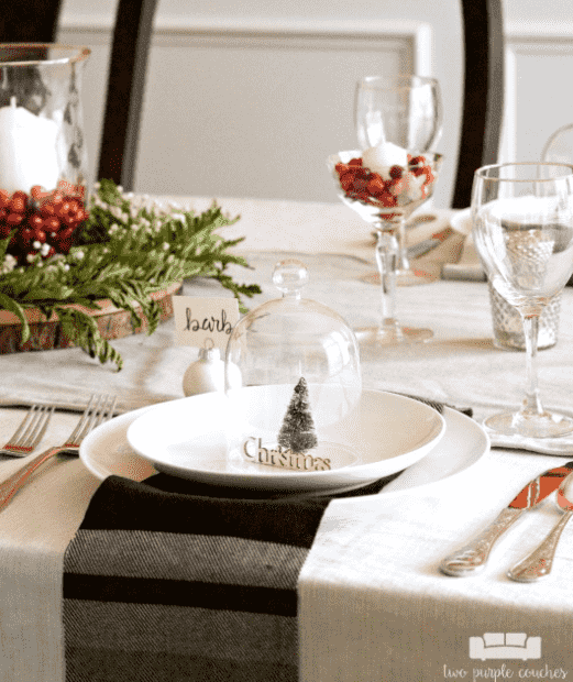 Table decor with candles and greenery.