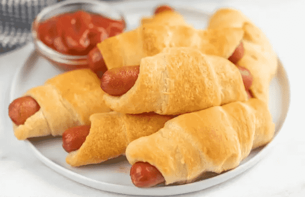 Pigs in a blanket on platter.