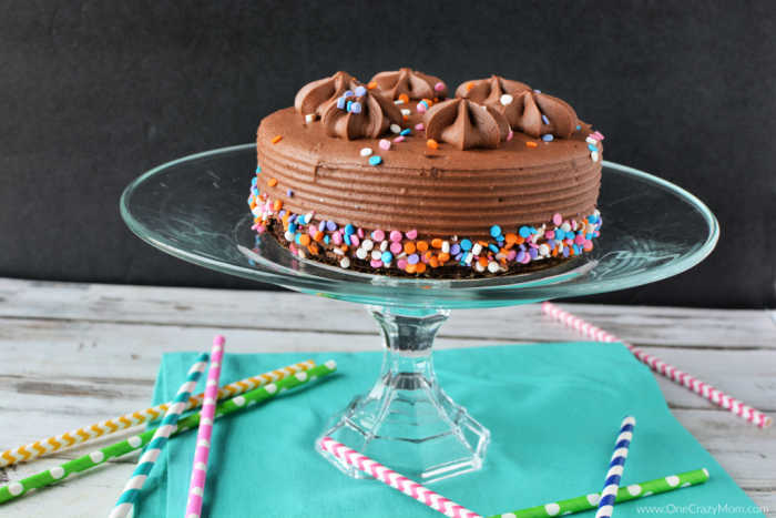 Cake plate with chocolate cake on top.
