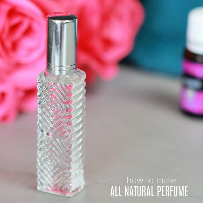 Perfume on counter in front of roses.