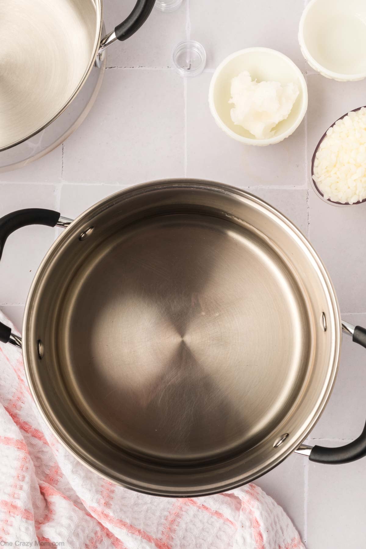 Bottom portion of double boiler with water.