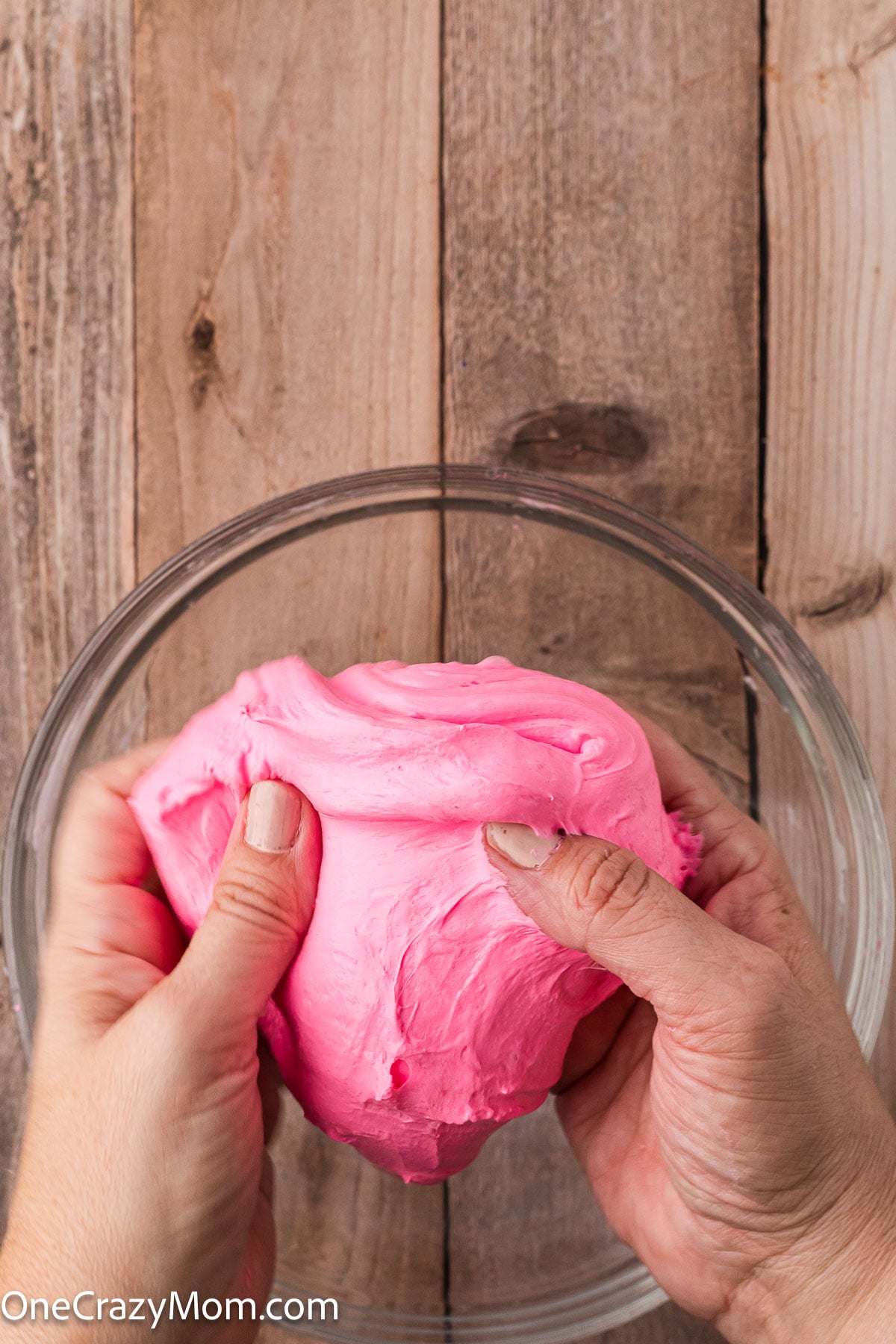 Slime in hands being stretched.