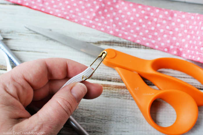 Safety pin attached to elastic.