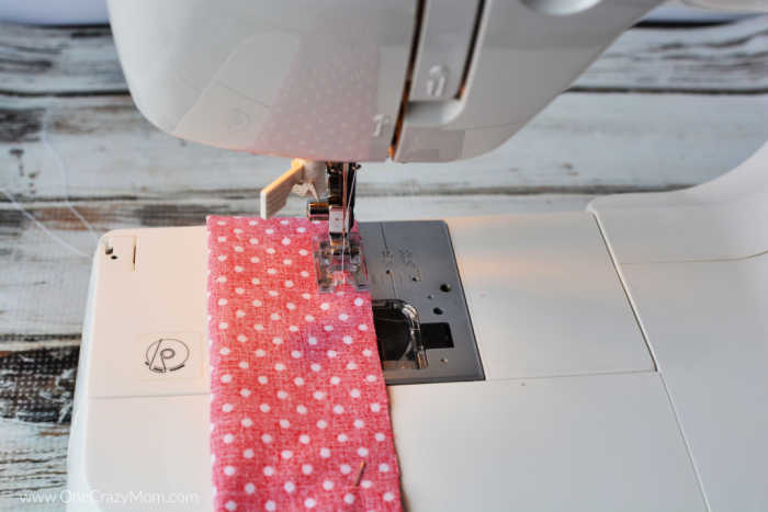 Fabric being sewn with sewing machine.