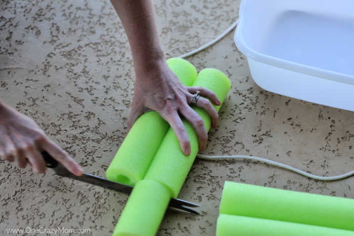 Pool noodle being cut.