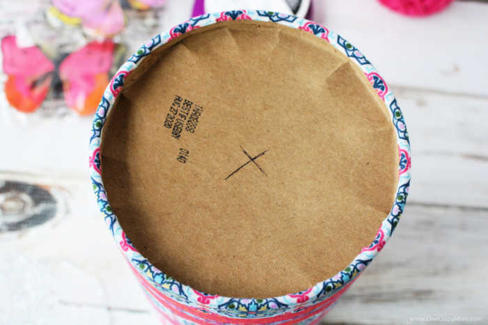 Lid of container being marked.